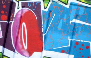 Colorful background of graffiti painting artwork with bright aerosol outlines on wall. Old school street art piece made with aerosol spray paint cans. Contemporary youth culture photo