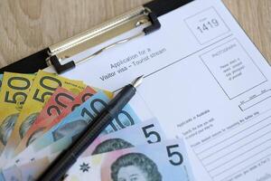 KYIV, UKRAINE - JULY 10, 2024 Australian application for a visitor visa Form 1419 to travel to Australia on table photo