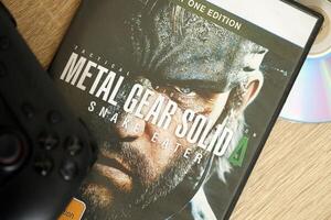 KYIV, UKRAINE - JUNE 26, 2024 Metal Gear Solid Delta Snake Eater PS5 game disc box for console gaming. Popular game disc photo