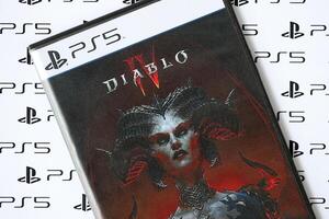 KYIV, UKRAINE - JUNE 26, 2024 Diablo 4 PS5 game disc box for console gaming. Popular game disc photo