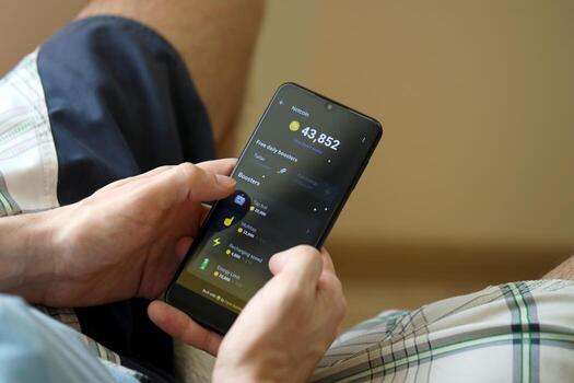 KYIV, UKRAINE - APRIL 20, 2024 Notcoin telegram bot on smartphone screen. Notcoin is a viral Telegram based crypto game for earn tokens by managing virtual crypto exchange photo