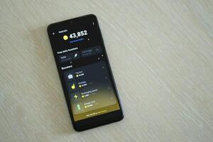KYIV, UKRAINE - APRIL 20, 2024 Notcoin telegram bot on smartphone screen. Notcoin is a viral Telegram based crypto game for earn tokens by managing virtual crypto exchange photo