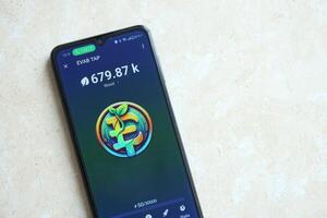 KYIV, UKRAINE - APRIL 20, 2024 EVAB TAP telegram bot on smartphone screen. EVAB TAP is a viral Telegram based crypto game for earn tokens by managing virtual crypto exchange photo