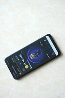 KYIV, UKRAINE - APRIL 20, 2024 Hamster Kombat telegram bot on smartphone screen. Hamster Kombat is a viral Telegram crypto game for earn HMSTR tokens by managing virtual crypto exchange photo
