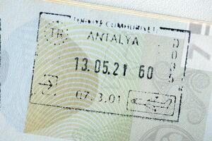 KYIV, UKRAINE - APRIL 20, 2024 Page of foreign passport with visas, Turkiye border stamps, permits to enter countries, concept of traveling around the world, travelers document photo