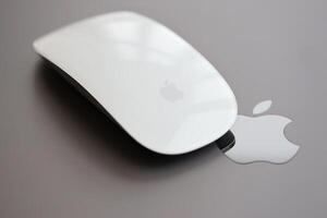 KYIV, UKRAINE - NOVEMBER 27, 2023 Apple Magic Mouse 3rd generation lies with grey MacBook 2021 photo