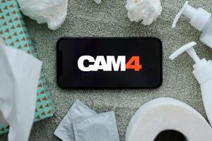 KYIV, UKRAINE - JANUARY 23, 2024 Cam4 adult content website logo on display of iPhone 12 Pro photo
