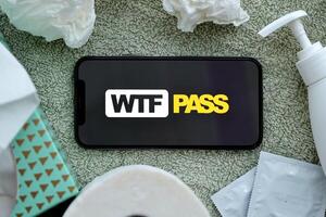 KYIV, UKRAINE - JANUARY 23, 2024 WTFPass adult content website logo on display of iPhone 12 Pro photo