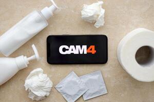 KYIV, UKRAINE - JANUARY 23, 2024 Cam4 adult content website logo on display of iPhone 12 Pro photo