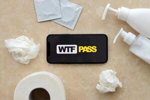 KYIV, UKRAINE - JANUARY 23, 2024 WTFPass adult content website logo on display of iPhone 12 Pro photo
