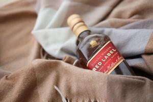 KYIV, UKRAINE - NOVEMBER 27, 2023 Johnnie Walker red label scotch whisky bottle photo