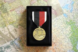 KYIV, UKRAINE - JULY 10, 2024 US Army of Occupation medal. United States military award medal with ribbon and pin. Handmade paper theater props photo