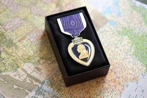 KYIV, UKRAINE - JULY 10, 2024 US Purple Heart medal. United States military award medal with ribbon and pin. Handmade paper theater props photo