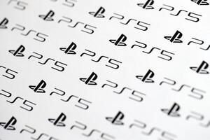 KYIV, UKRAINE - JUNE 26, 2024 Sony Playstation 5 console logo repeating many times on white paper background banner photo