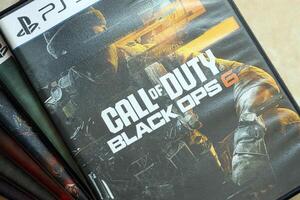 KYIV, UKRAINE - JUNE 26, 2024 Call of Duty Black Ops 6 PS5 game disc box for console gaming. Popular game disc photo