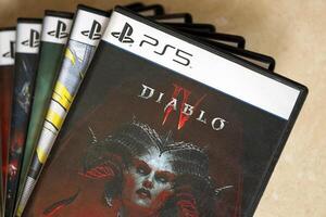 KYIV, UKRAINE - JUNE 26, 2024 Diablo 4 PS5 game disc box for console gaming. Popular game disc photo