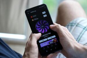 KYIV, UKRAINE - APRIL 20, 2024 Tronix App telegram bot on smartphone screen. Tronix App is a viral Telegram based crypto game for earn TRX tokens by managing virtual crypto exchange photo