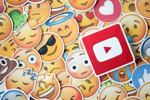 KYIV, UKRAINE - APRIL 20, 2024 YouTube logo and large set of stickers with Emoji yellow faces. Emoji is a pictogram or smiley embedded in text and used in electronic messages photo