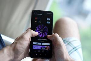 KYIV, UKRAINE - APRIL 20, 2024 Tronix App telegram bot on smartphone screen. Tronix App is a viral Telegram based crypto game for earn TRX tokens by managing virtual crypto exchange photo