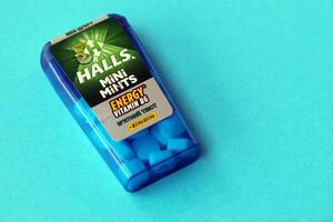 KYIV, UKRAINE - APRIL 20, 2024 Halls mini mints mint twist energy vitamin b6 small blue case with hard mints inside on blue background photo