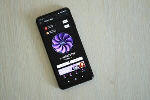 KYIV, UKRAINE - APRIL 20, 2024 Tronix App telegram bot on smartphone screen. Tronix App is a viral Telegram based crypto game for earn TRX tokens by managing virtual crypto exchange photo