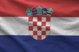 Croatia flag depicted on folded wavy fabric of old cloth photo