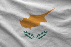 Cyprus flag depicted on folded wavy fabric of old cloth photo