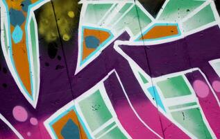 Colorful background of graffiti painting artwork with bright aerosol outlines on wall. Old school street art piece made with aerosol spray paint cans. Contemporary youth culture photo