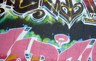 Colorful background of graffiti painting artwork with bright aerosol outlines on wall. Old school street art piece made with aerosol spray paint cans. Contemporary youth culture photo