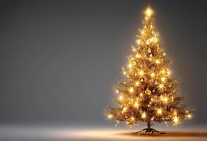 Shimmering Christmas tree with golden lights on grey background. A New Year's card with a place for the text. photo