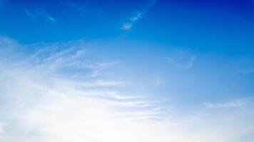 Clear blue sky with soft white clouds symbolizing tranquility, perfect for spring or summer backgrounds, and nature related concepts photo