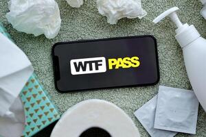 KYIV, UKRAINE - JANUARY 23, 2024 WTFPass adult content website logo on display of iPhone 12 Pro photo