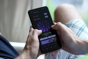 KYIV, UKRAINE - APRIL 20, 2024 Tronix App telegram bot on smartphone screen. Tronix App is a viral Telegram based crypto game for earn TRX tokens by managing virtual crypto exchange photo