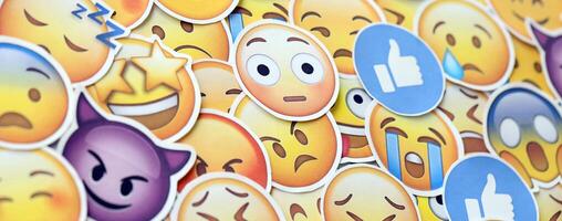 KYIV, UKRAINE - APRIL 20, 2024 Large set of stickers with Emoji yellow faces. Emoji is a pictogram or smiley embedded in text and used in electronic messages photo