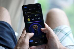 KYIV, UKRAINE - APRIL 20, 2024 Hamster Kombat telegram bot on smartphone screen. Hamster Kombat is a viral Telegram crypto game for earn HMSTR tokens by managing virtual crypto exchange photo