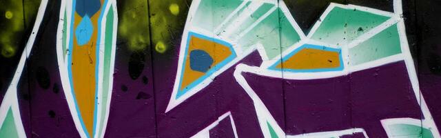 Colorful background of graffiti painting artwork with bright aerosol outlines on wall. Old school street art piece made with aerosol spray paint cans. Contemporary youth culture photo