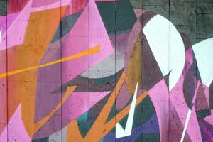 Colorful background of graffiti painting artwork with bright aerosol outlines on wall. Old school street art piece made with aerosol spray paint cans. Contemporary youth culture photo