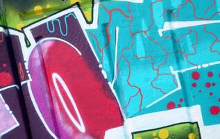 Colorful background of graffiti painting artwork with bright aerosol outlines on wall. Old school street art piece made with aerosol spray paint cans. Contemporary youth culture photo