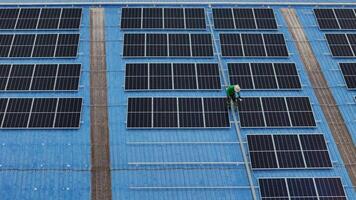 Worker Technicians are working to construct solar panels system on roof. Installing solar photovoltaic panel system. Men technicians carrying photovoltaic solar modules on roof. video