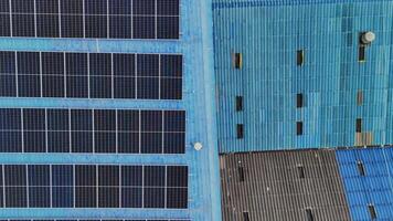 Worker Technicians are working to construct solar panels system on roof. Installing solar photovoltaic panel system. Men technicians carrying photovoltaic solar modules on roof. video