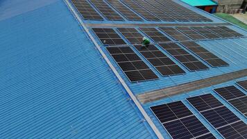 Worker Technicians are working to construct solar panels system on roof. Installing solar photovoltaic panel system. Men technicians carrying photovoltaic solar modules on roof. video