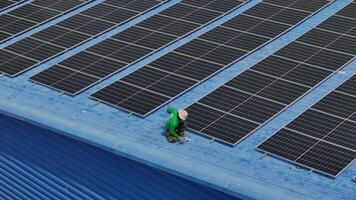 Worker Technicians are working to construct solar panels system on roof. Installing solar photovoltaic panel system. Men technicians carrying photovoltaic solar modules on roof. video