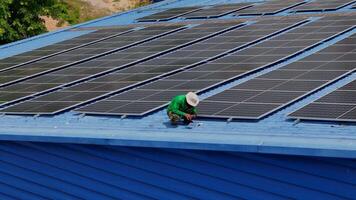 Worker Technicians are working to construct solar panels system on roof. Installing solar photovoltaic panel system. Men technicians carrying photovoltaic solar modules on roof. video