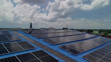 Worker Technicians are working to construct solar panels system on roof. Installing solar photovoltaic panel system. Men technicians carrying photovoltaic solar modules on roof. video