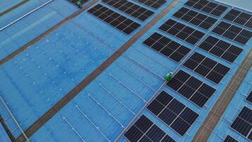 Worker Technicians are working to construct solar panels system on roof. Installing solar photovoltaic panel system. Men technicians carrying photovoltaic solar modules on roof. video