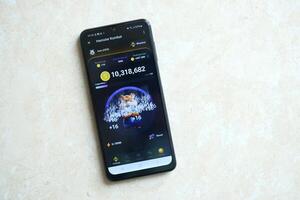 KYIV, UKRAINE - APRIL 20, 2024 Hamster Kombat telegram bot on smartphone screen. Hamster Kombat is a viral Telegram crypto game for earn HMSTR tokens by managing virtual crypto exchange photo
