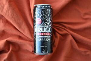 KYIV, UKRAINE - APRIL 20, 2024 Frugo energy drink in black can on orange fabric. Frugo is now owned by Food Care Poland photo