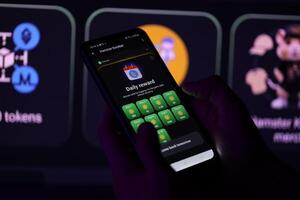 KYIV, UKRAINE - APRIL 20, 2024 Hamster Kombat telegram bot on smartphone screen. Hamster Kombat is a viral Telegram-based crypto game for earn HMSTR tokens by managing virtual crypto exchange photo