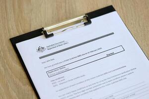 KYIV, UKRAINE - JULY 10, 2024 Application status for Australian visitor visa on table of Australian Government Department of Home Affairs photo