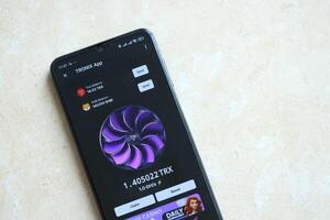 KYIV, UKRAINE - APRIL 20, 2024 Tronix App telegram bot on smartphone screen. Tronix App is a viral Telegram based crypto game for earn TRX tokens by managing virtual crypto exchange photo